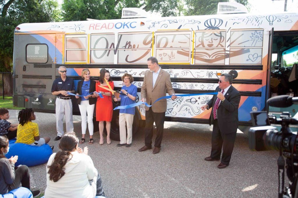 Ribbon cutting in front of OKCPS Book Bus